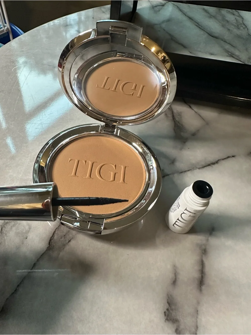 TIGI Compact Pressed Setting Powder color- Entice, black liquid eyeliner